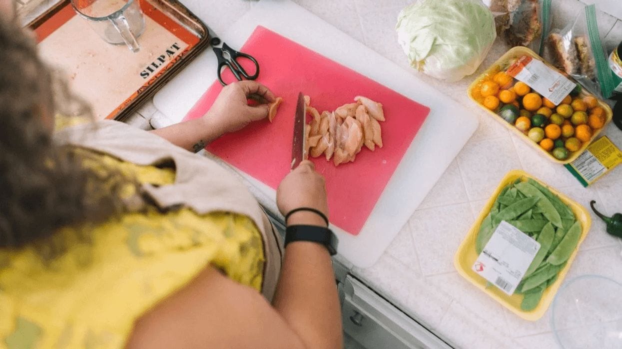 The 10 most important foods to eat during pregnancy mom cutting chicken on a cutting board