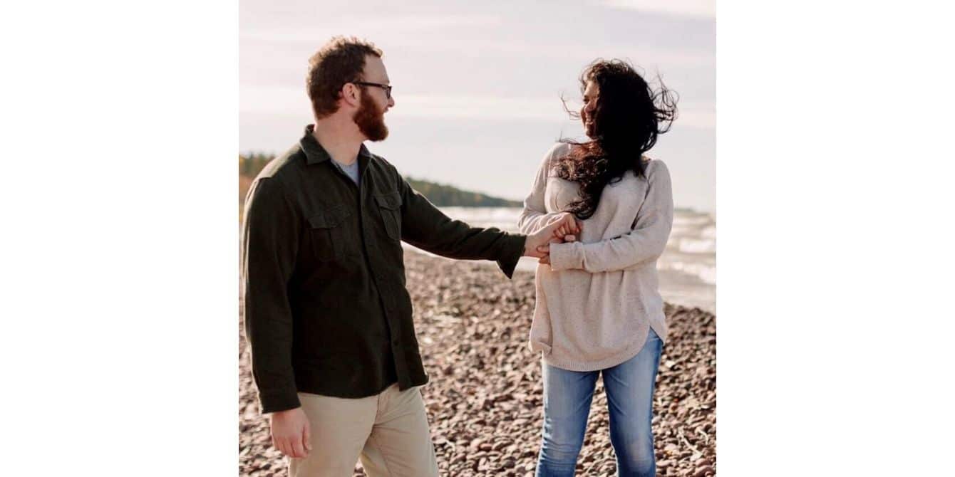 Lauren on not allowing mental illness and postpartum depression to define her man and woman standing in a field holding hands - my mental illness does not define me essay