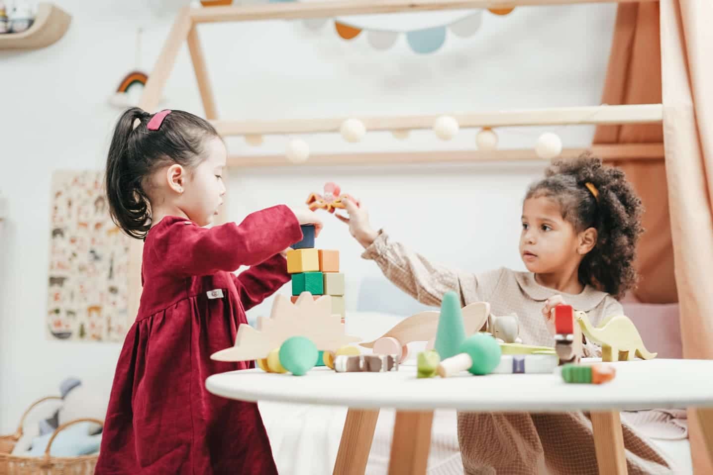 How to turn a playroom into a preschool classroom kids playing at a table