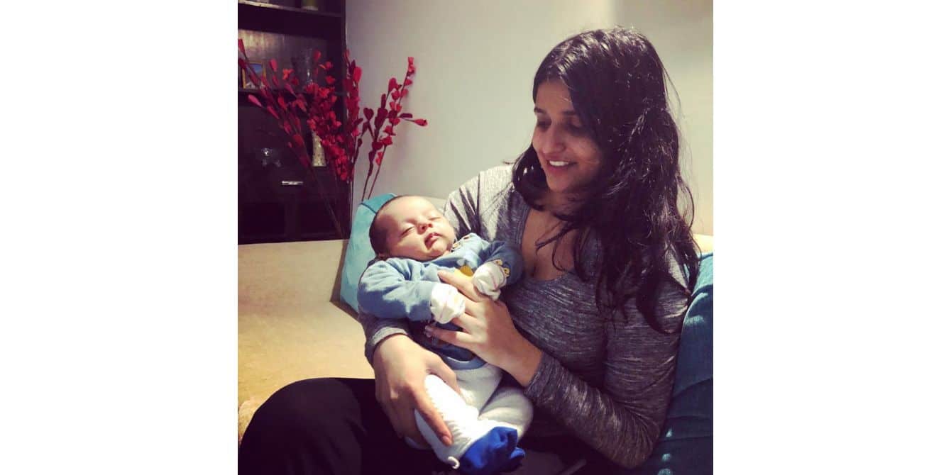 Sanyya on health anxiety while raising a baby during a global pandemic picture of a mom holding her baby in her arms - essay on raising a baby during a global pandemic