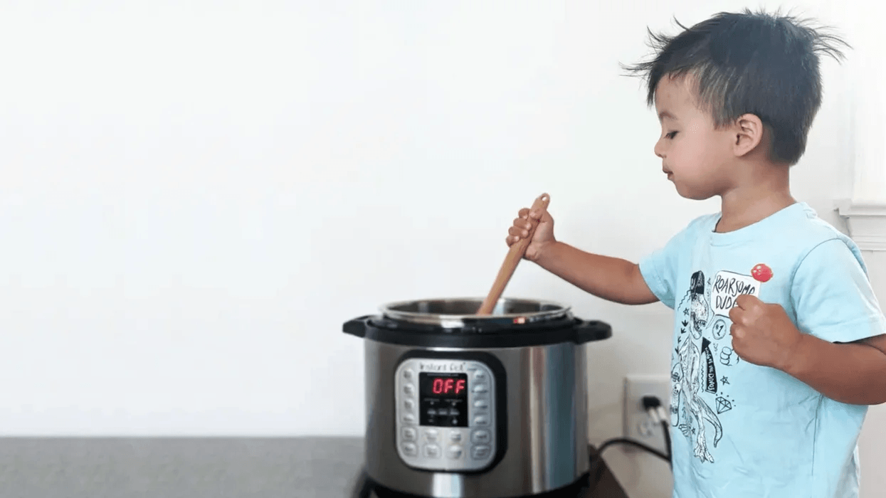 Deal alert: Our favorite Instant Pot is on sale on Amazon today 👏 toddler stirring food in an instant pot