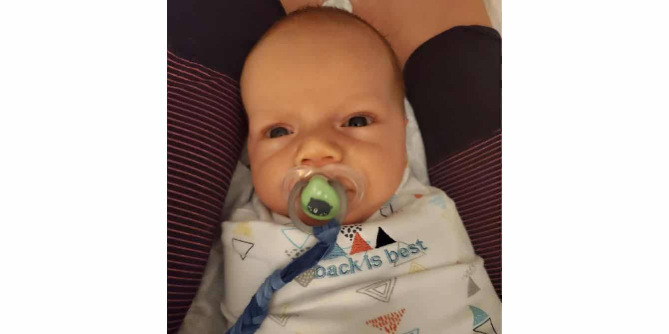 Jess on having postpartum depression and feeling isolated and alone during Covid-19 picture of a baby with a pacifier - essay on feeling isolated during Covid-19