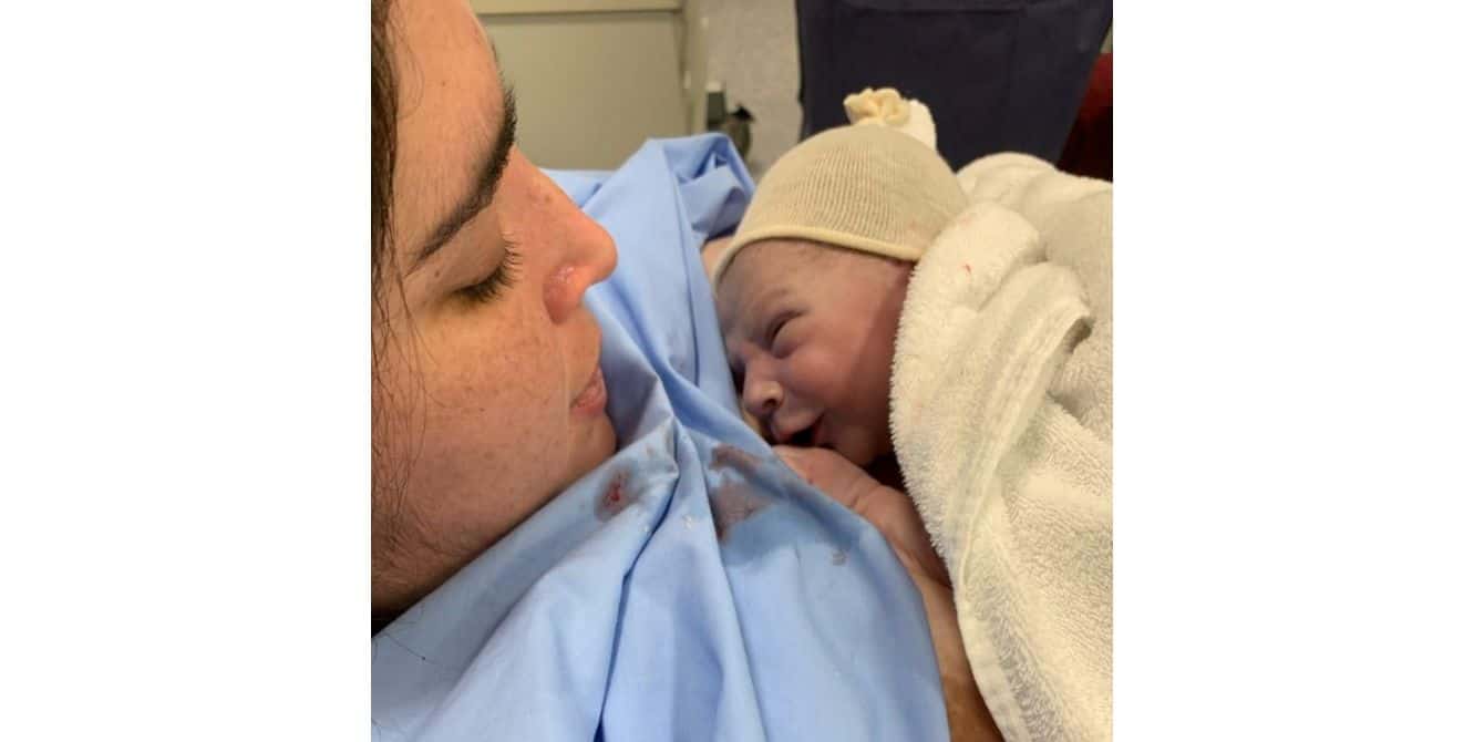 Karina on postpartum depression and struggling to find joy in motherhood women looking down at newborn baby - essay on struggling to find joy in motherhood