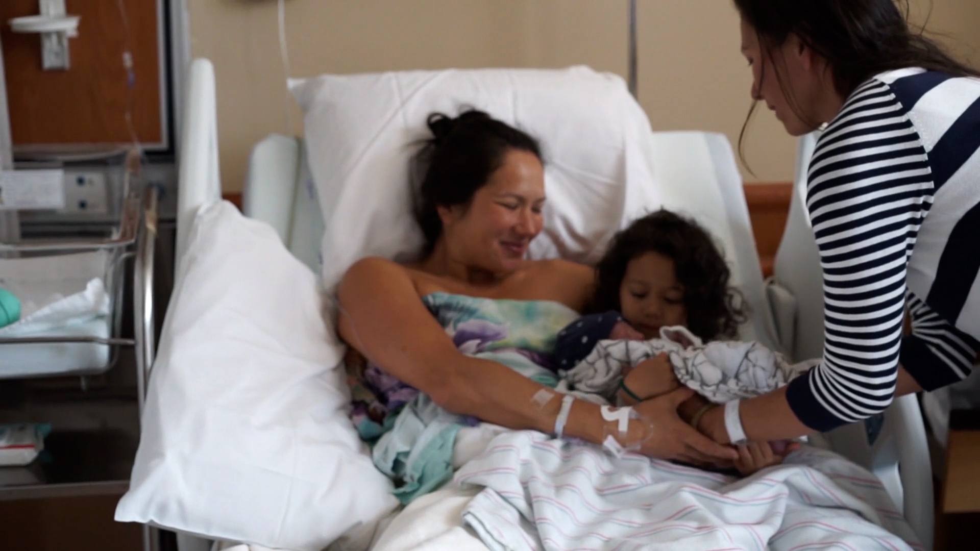 This is birth: With my sister by my side woman holding newborn baby with sister beside her