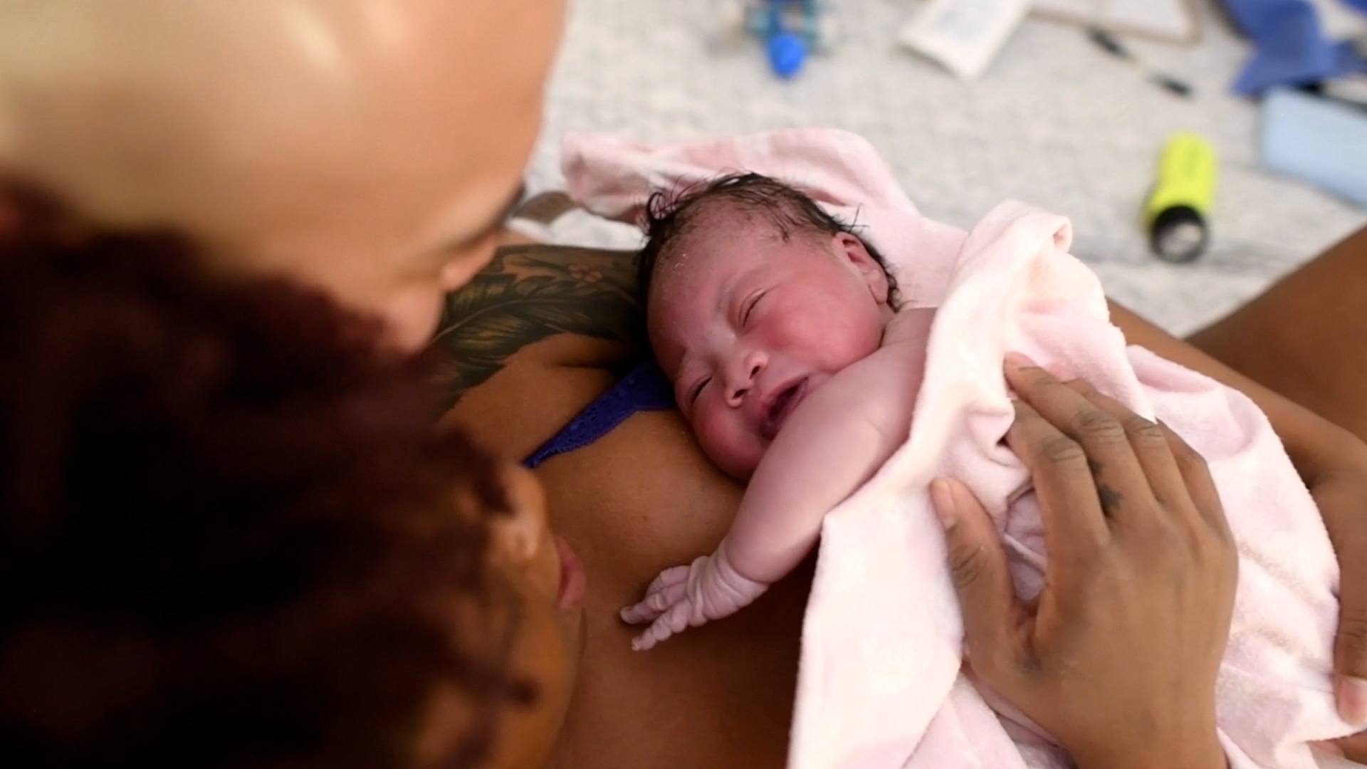 This is birth: A birth center story birth center: birth story mother holds newborn after giving birth