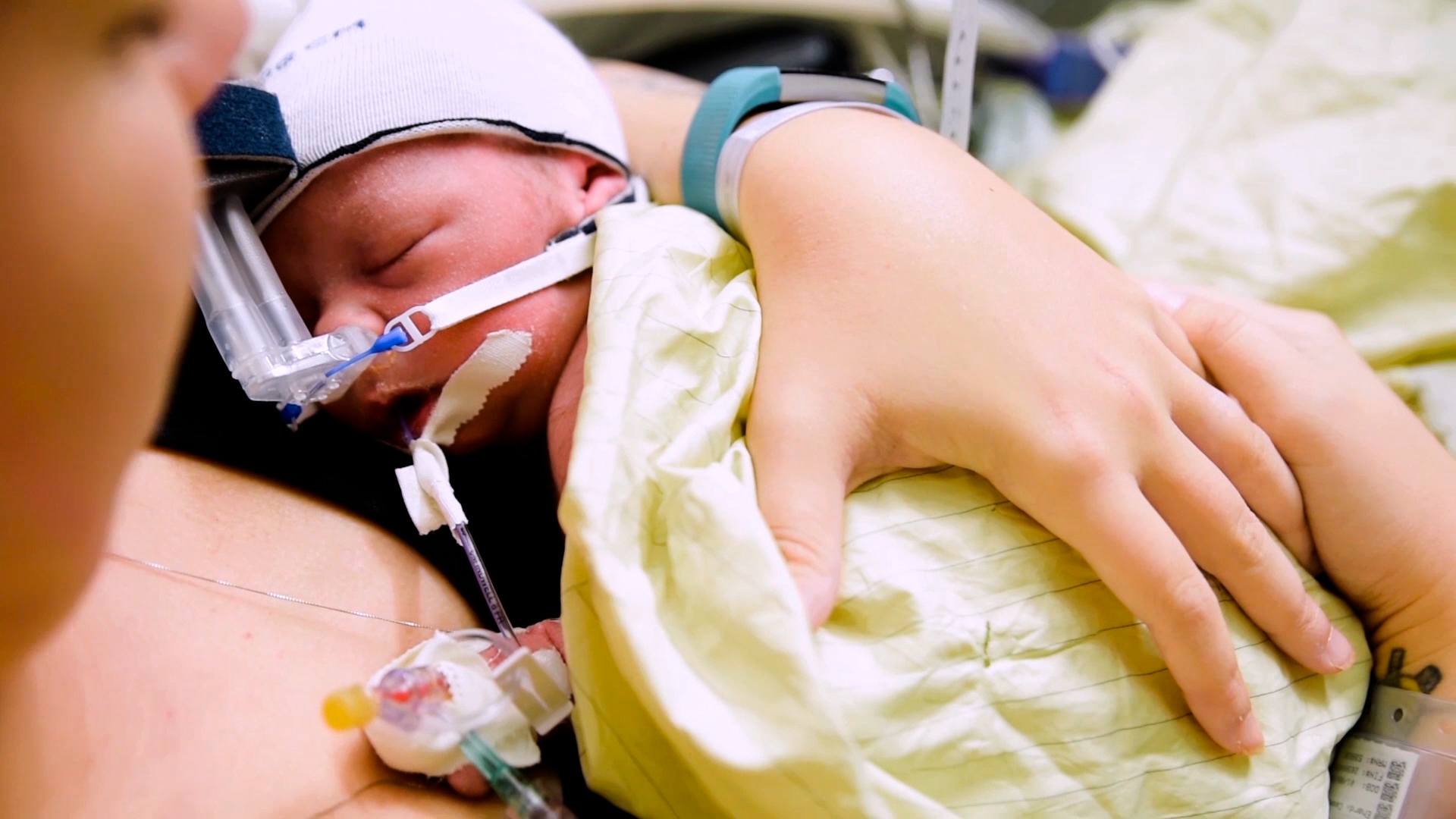 This is birth: A NICU birth story mom holding baby in the NICU