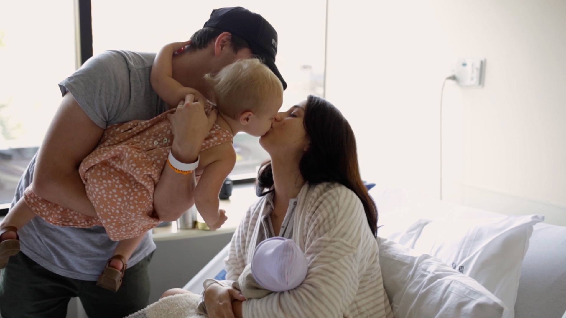 This is birth: An induced labor woman kissing baby while in delivery room