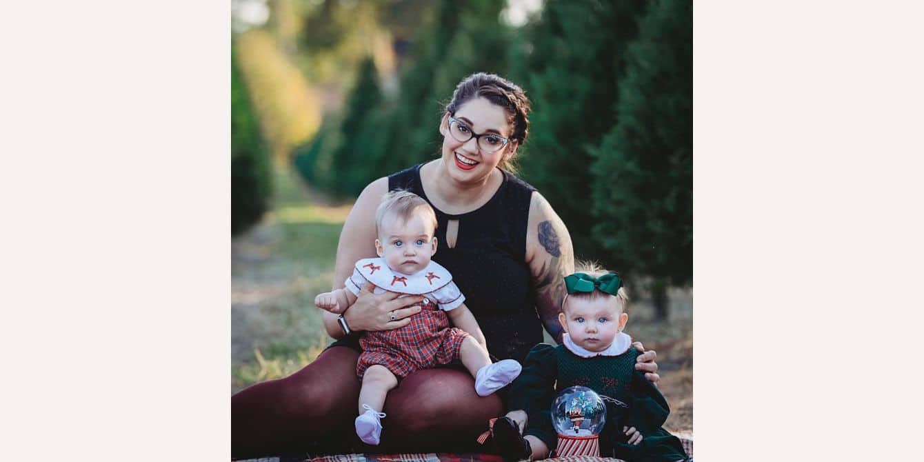 Sarah on clawing her way out of the postpartum depression darkness mom holding twins for a family photo - essay on getting out postpartum depression darkness
