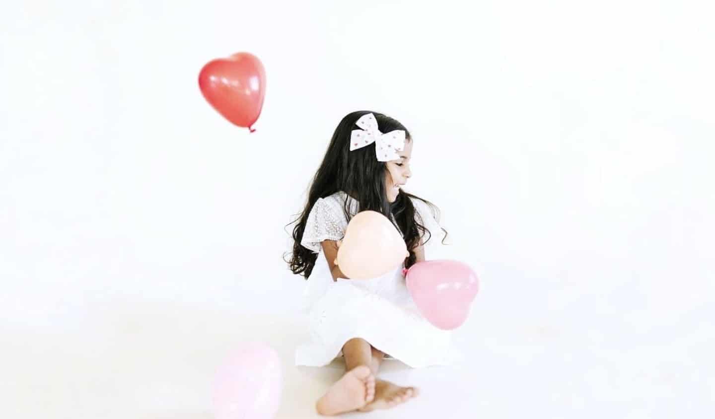 60+ candy-free Valentine’s Day gifts for all your little loves little girl with heart balloons-valentine's gifts for kids