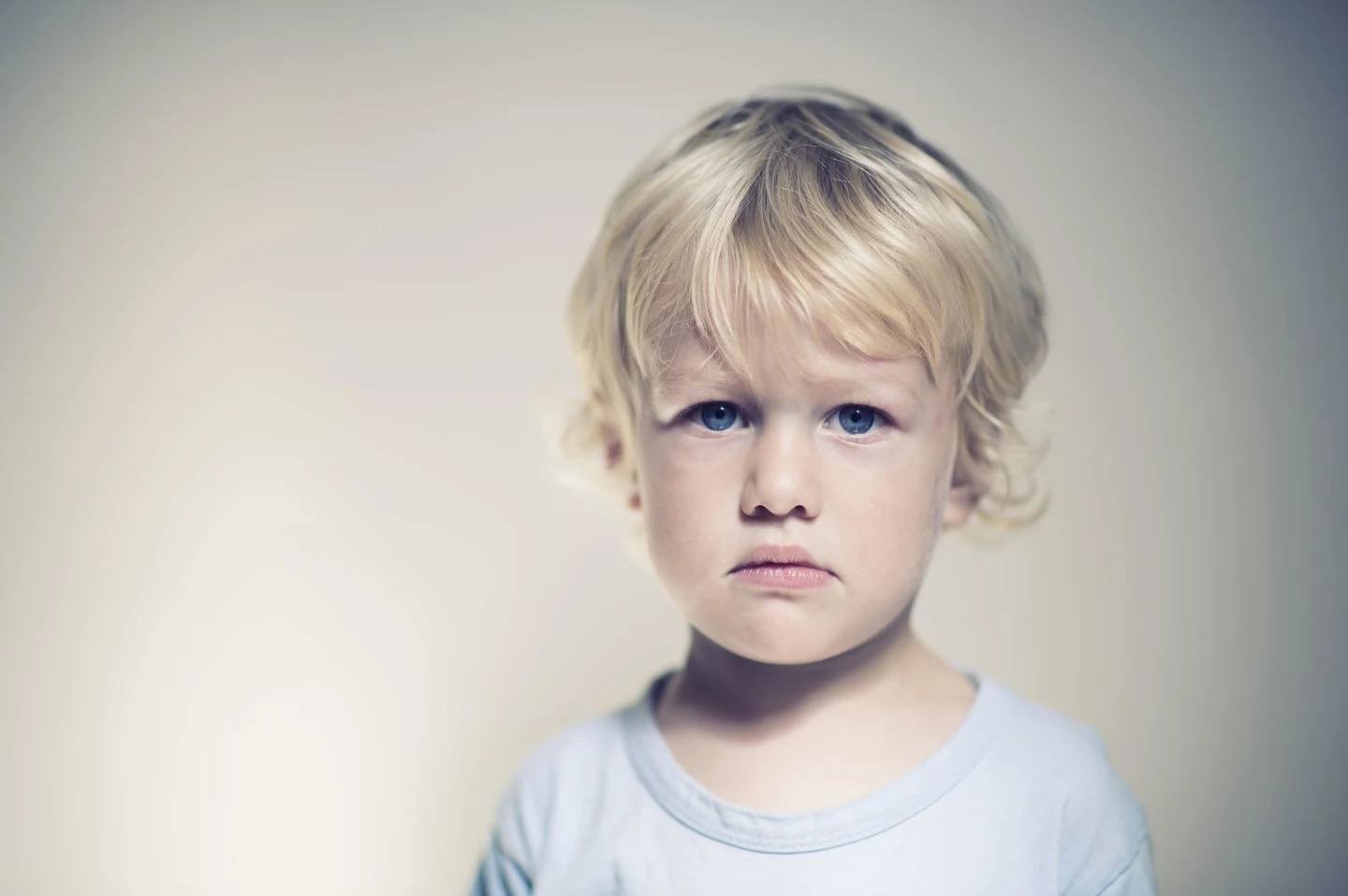 8 lies I believed about the terrible twos because everyone said they were the worst grumpy little boy looking at the camera