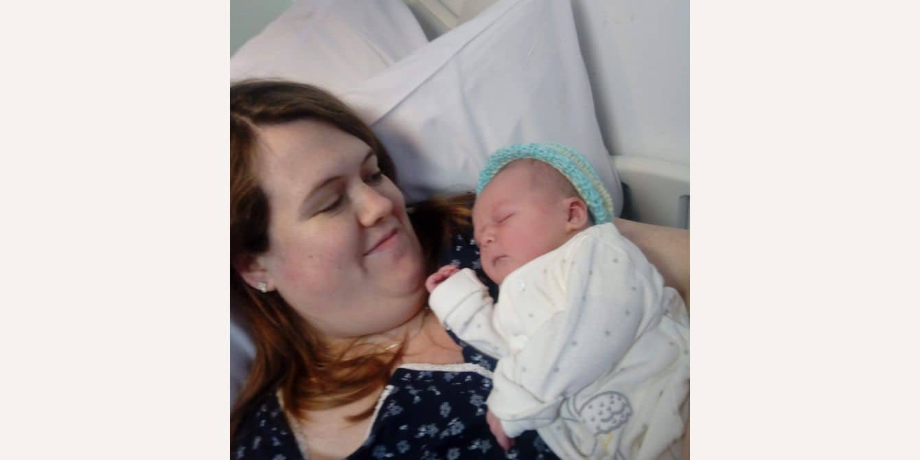 Frances on getting help after experiencing anxiety, depression and dark thoughts mom holding newborn in a hospital bed - essay on getting help after experiencing anxiety