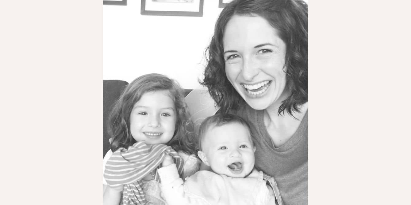 Emily on late onset postpartum depression in the form of anger and rage mom smiling with two kids - essay on late onset postpartum depression