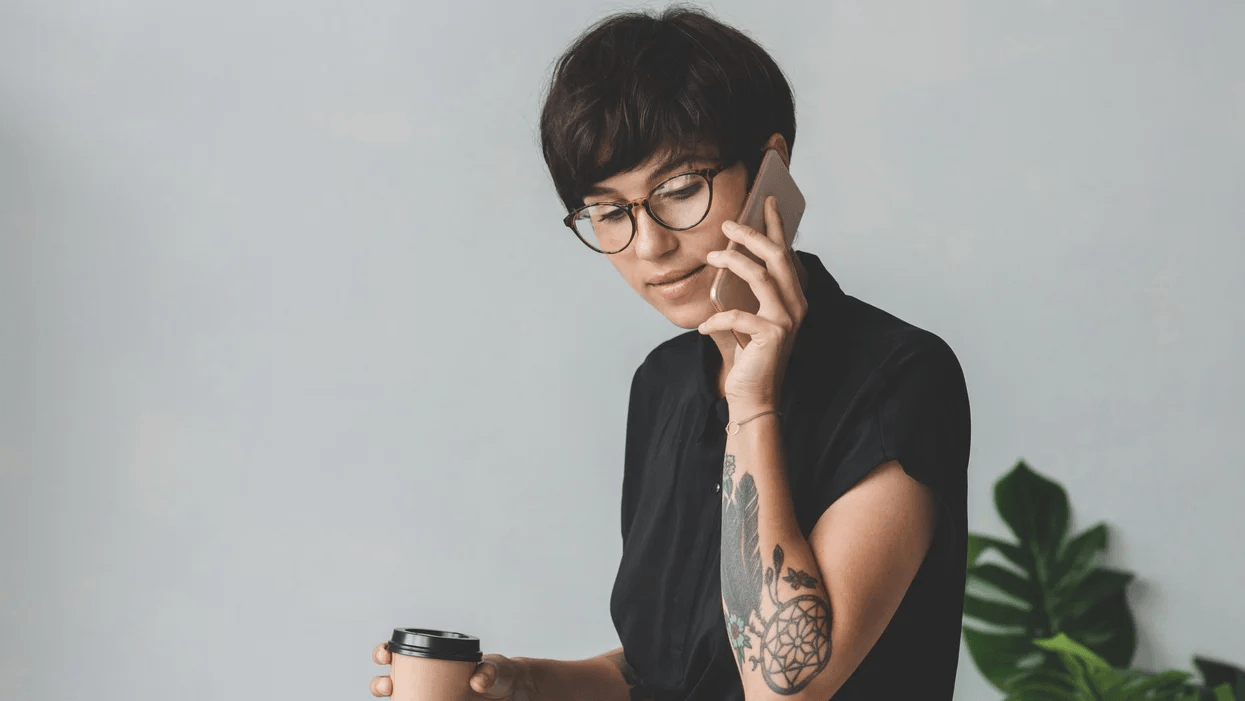 The U.S. is way behind in paid parental leave–but these 6 companies offer generous policies woman on the phone while holding a cup of coffee