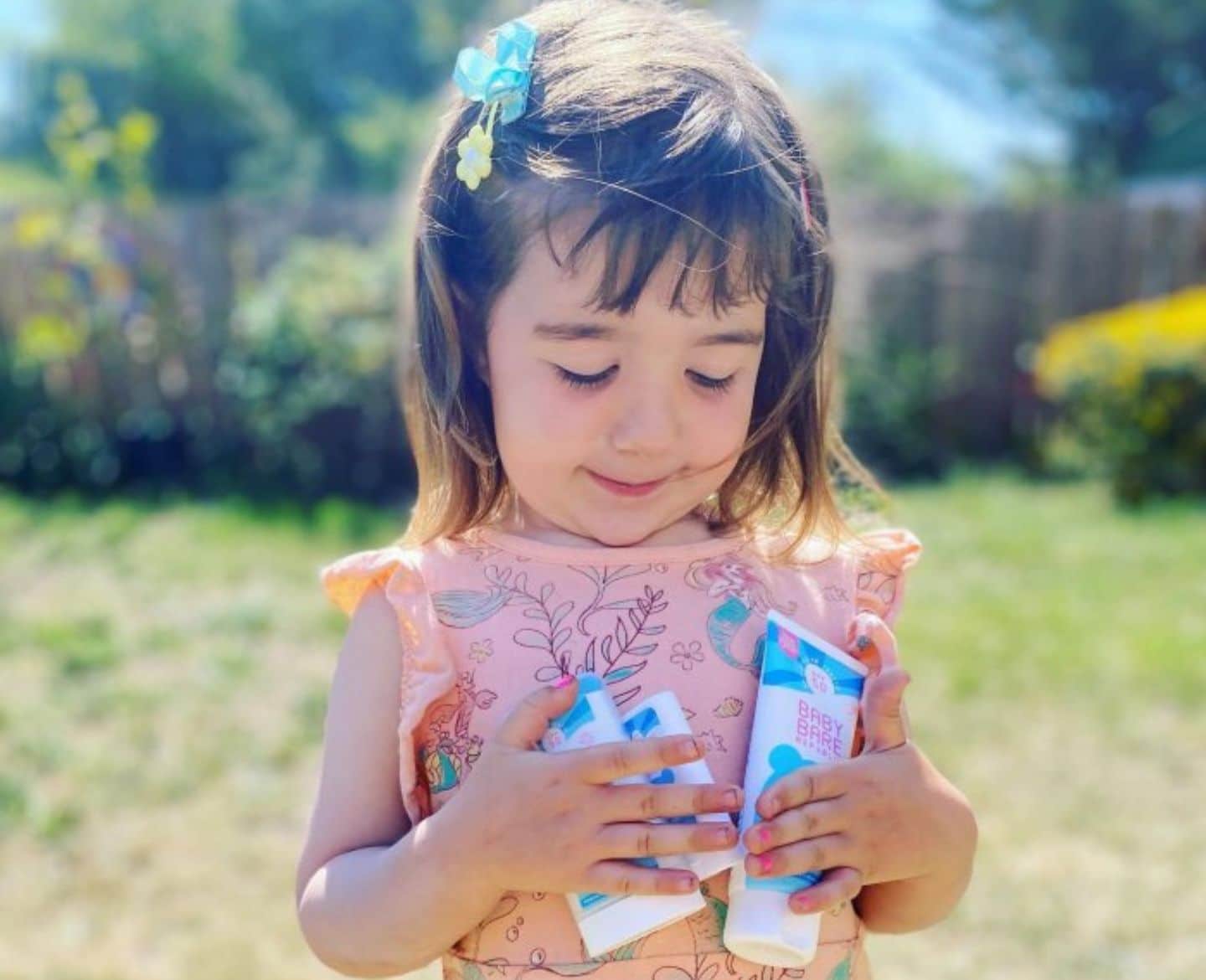 This baby sunscreen is a total game-changer 🙌 little girl holding sunscreen