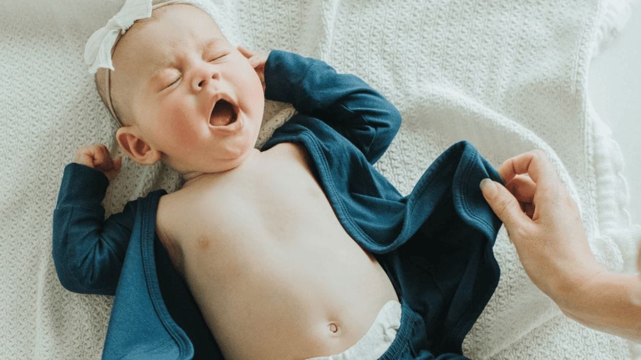 Practicing skin-to-skin? This is the babywear you need. yawning baby