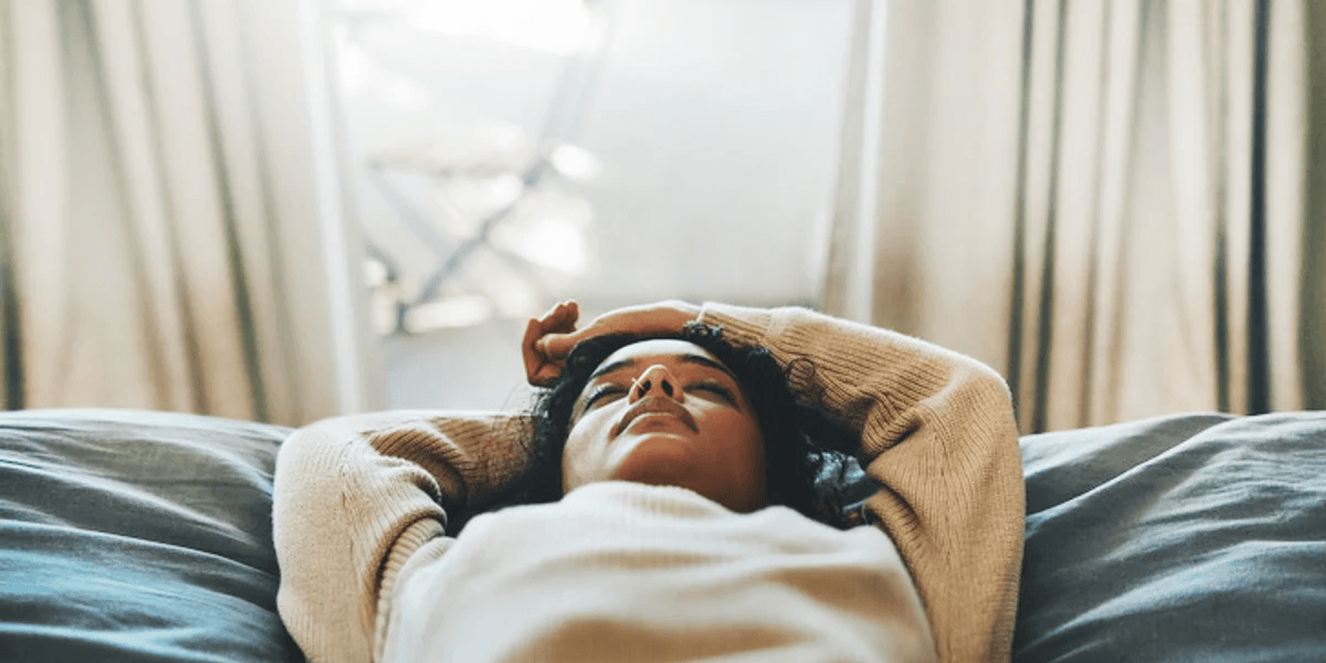 Errands and showers are not self-care for moms woman laying down with her hands above her head in an act of self care for moms
