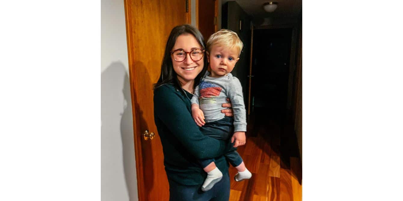 Julie on being told her postpartum anxiety and panic attacks were normal as a new mom women holding toddler and smiling - essay om postpartum anxiety attacks