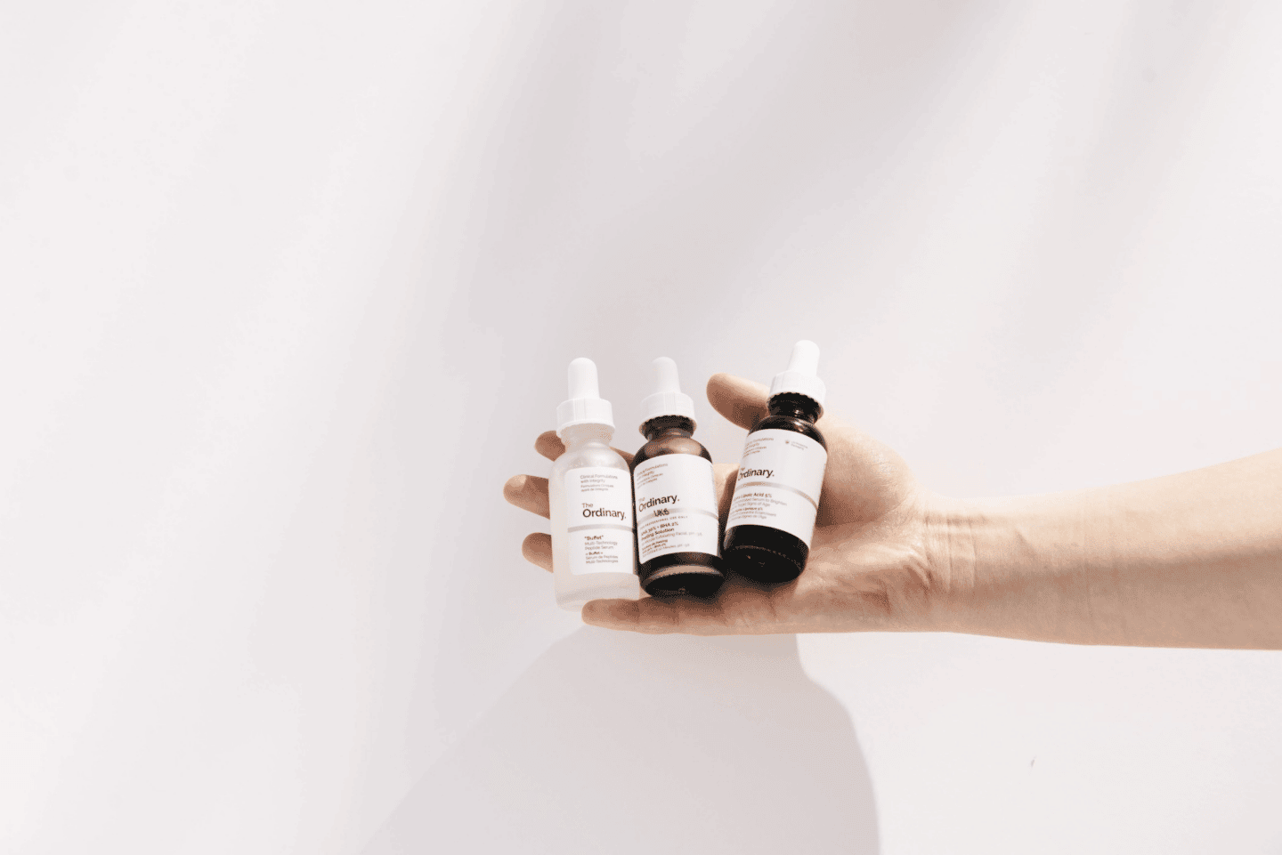 8 pregnancy-safe products to add to your beauty routine woman holding beauty products in her palm