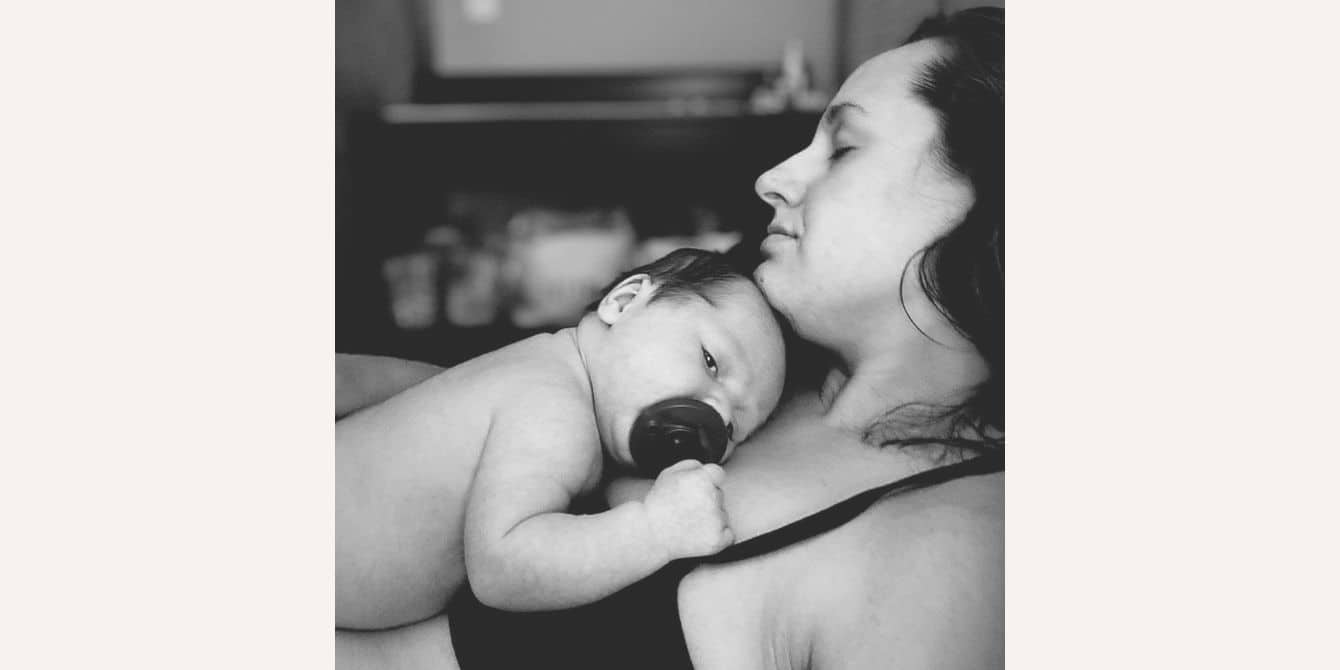 Stephanie on her ectopic pregnancy, IVF and experiencing postpartum depression and anxiety black and white photo of newborn sleeping on moms chest - essay on experiencing postpartum depression and anxiety