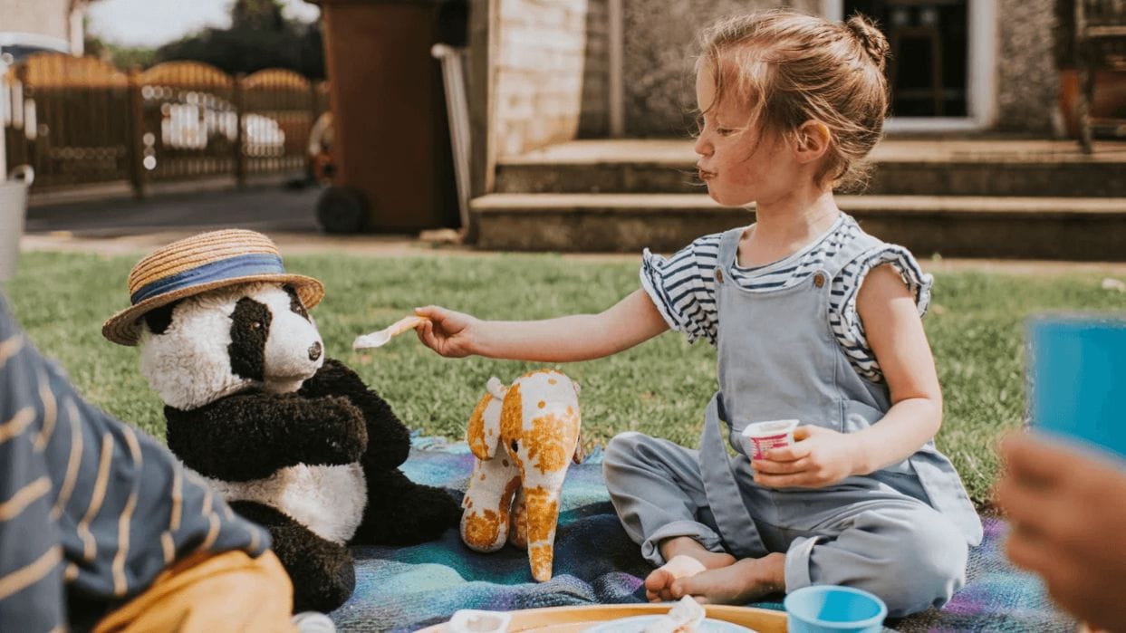 15 free & cheap ways to entertain your toddler all summer long little girl having a teddy bear picnic