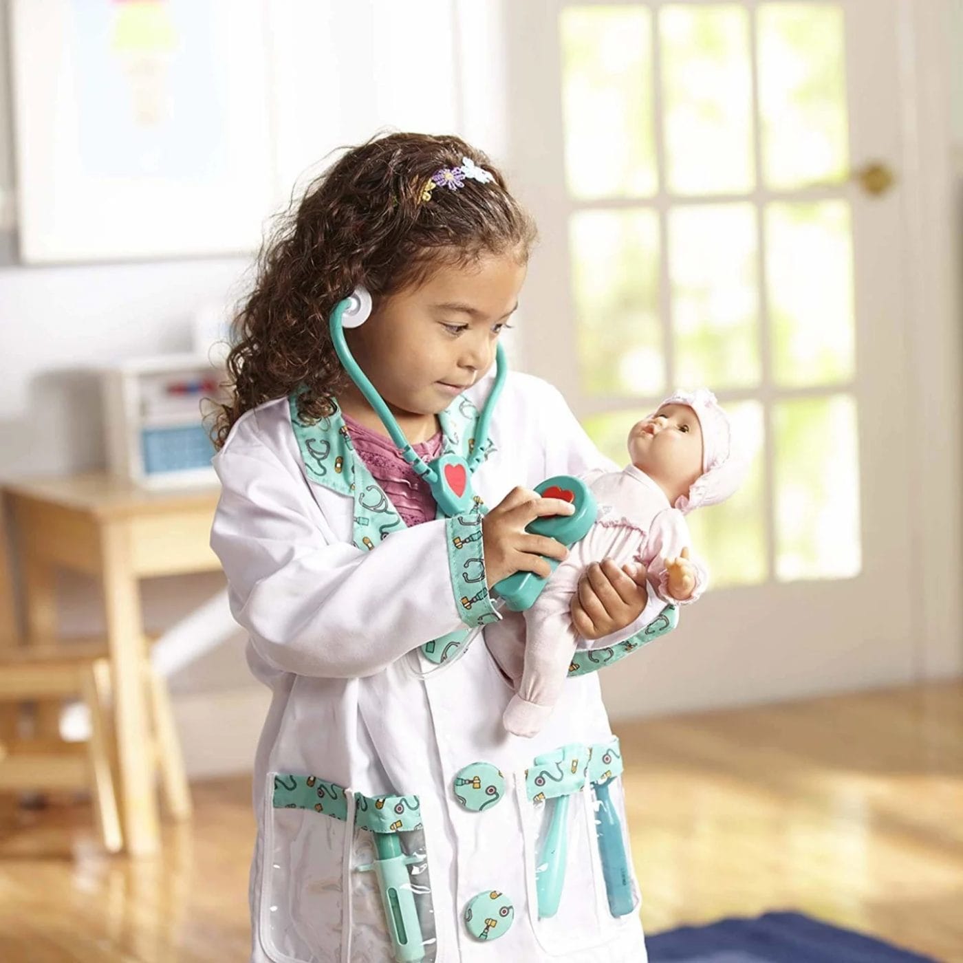 Amazon is having a massive Melissa & Doug sale right now–here’s what to shop little girl playing with the Melissa & Doug doctor kit