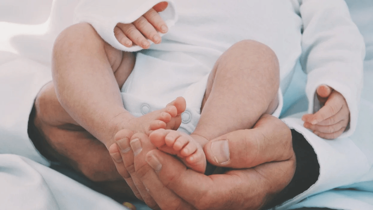 6 tips to REALLY prepare for the first year of fatherhood baby feet in father hands