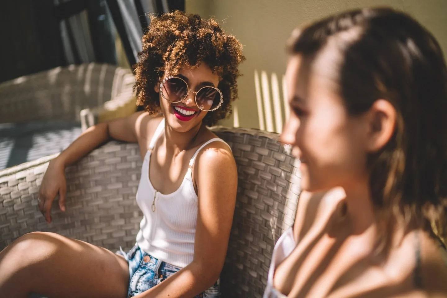 The 12 best face sunscreens to keep you radiant and protected two women sitting outside talking