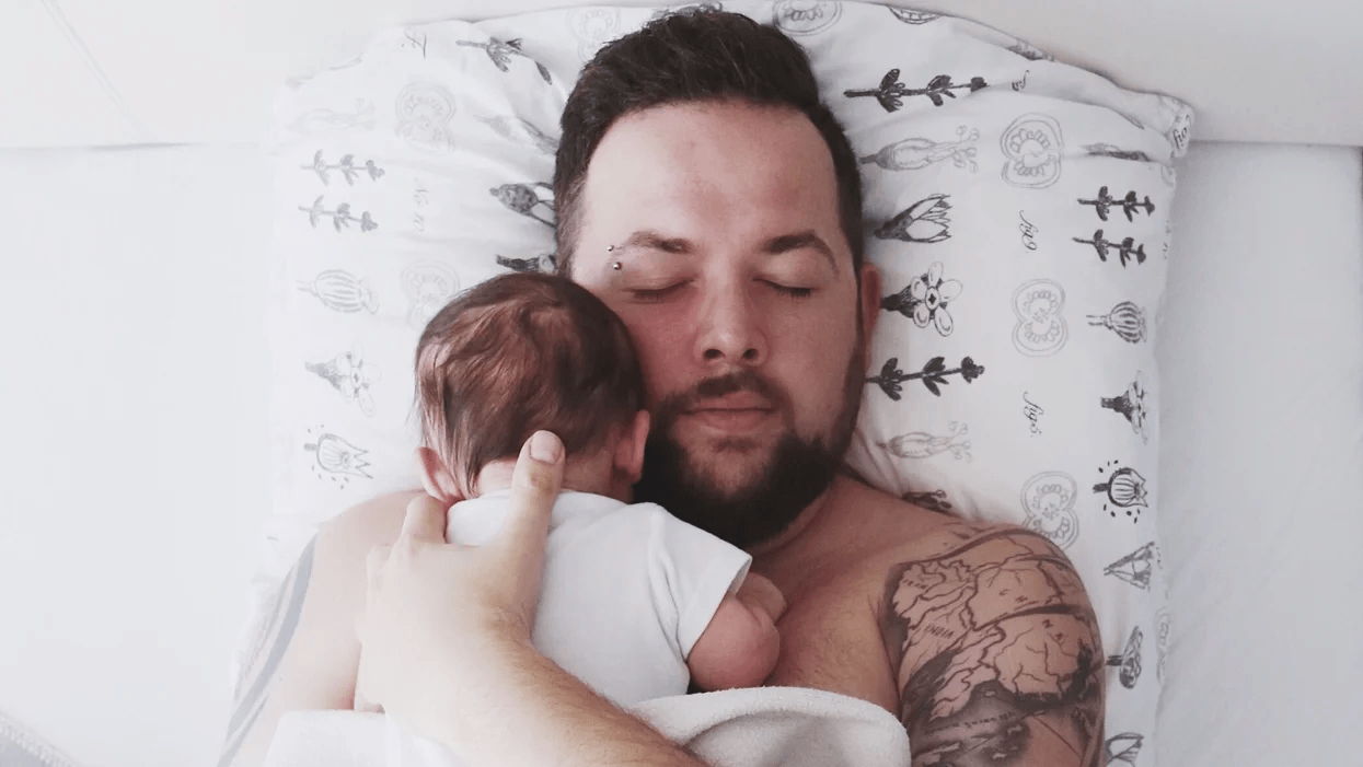 Fathers don’t get enough credit, either dad snuggling baby in bed