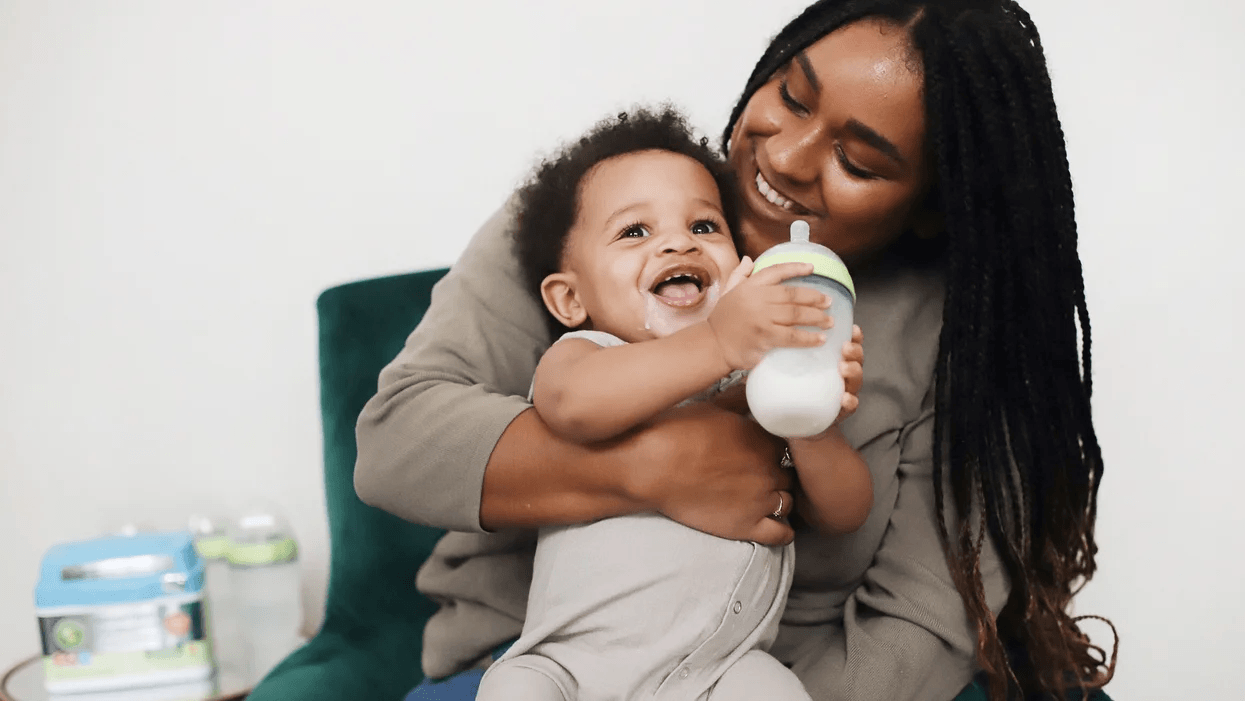 Time-saving formula tips our editors swear by mom giving a baby a formula bottle