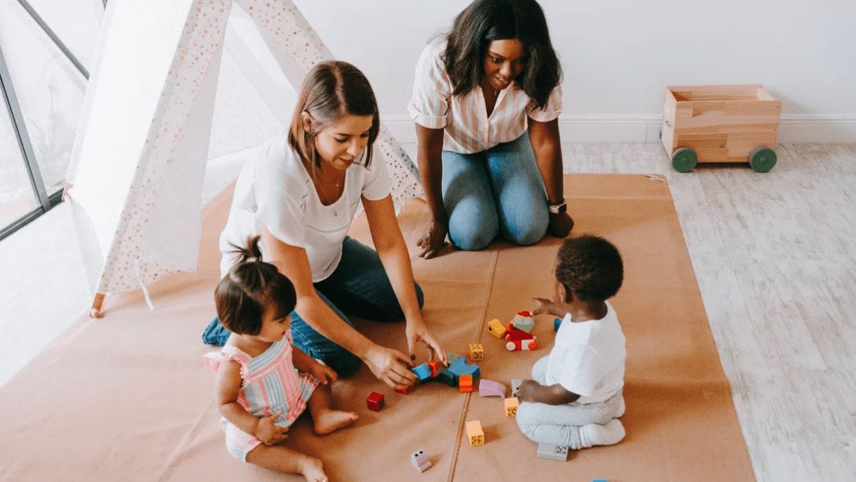 Why unstructured play is critical for brain development moms playing with kids on the floor