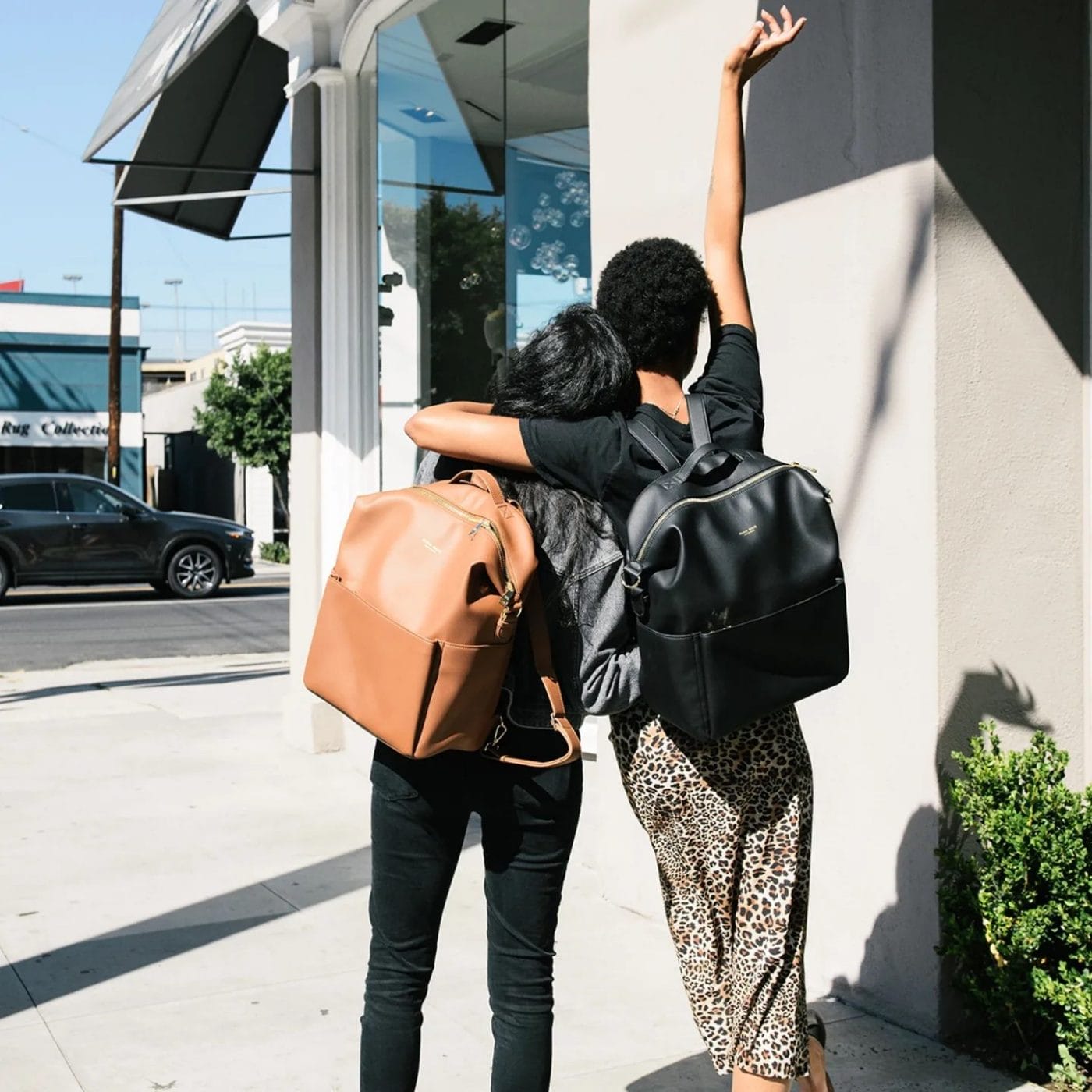 11 backpacks for moms who still carry all the things two women wearing backpacks