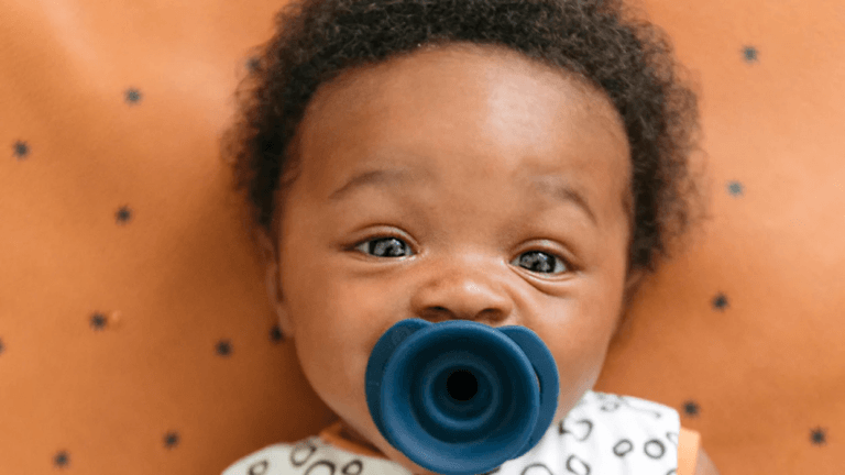 15 mama-innovated products that are total gamechangers baby with a pacifier