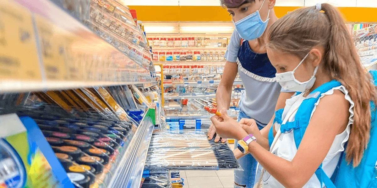 The ultimate back-to-school shopping list for busy moms kids shopping for school supplies in masks