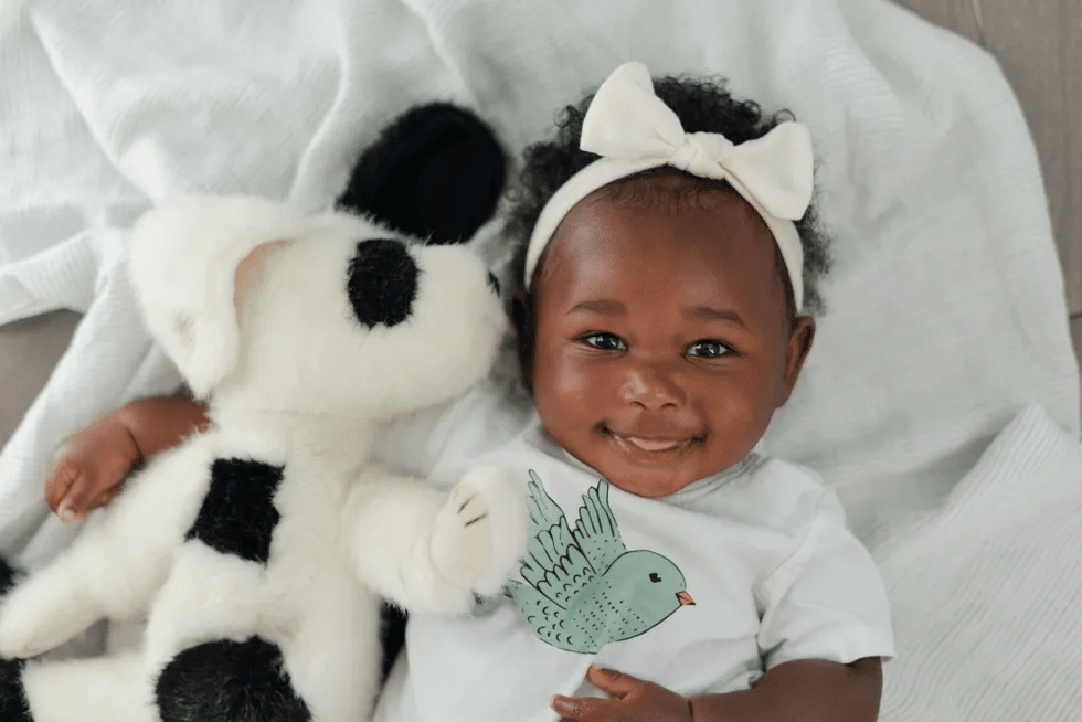 6-month-old baby milestones cute baby holding stuffed animal