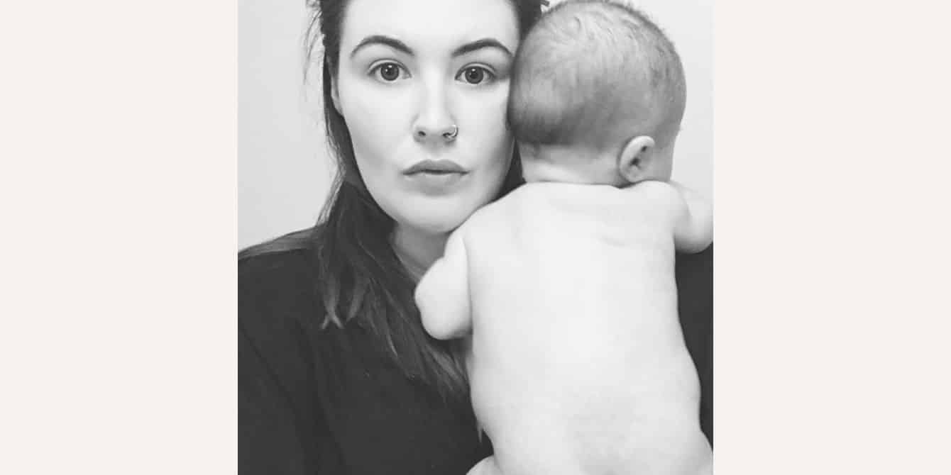 Catherine on experiencing postpartum anxiety and intrusive thoughts black and white photo of mom holding newborn baby - essay on experiencing postpartum anxiety