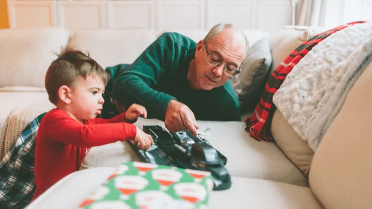 Please, no more toys—but if you want to give a gift, try this grandpa and boy christmas playing with toy- no more toys