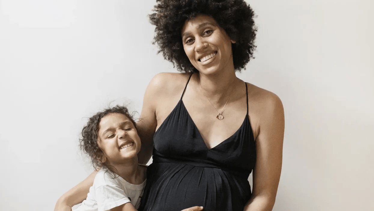 19 maternity outfits you’ll actually want to wear during the holidays pregnant-woman-side-hugging-her-daughter