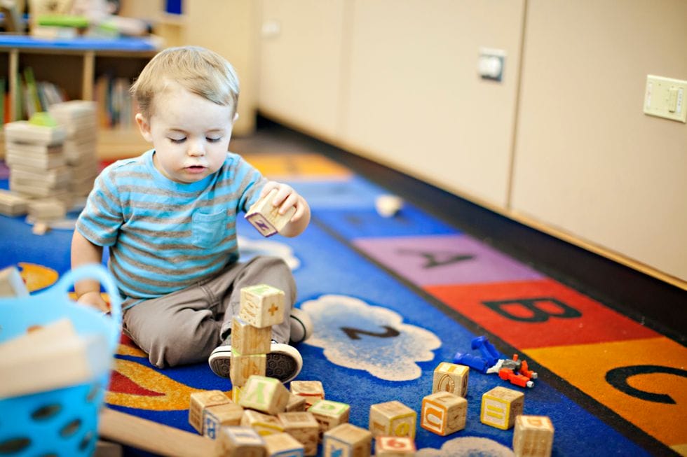 toddler stacking alphabet blocks that support bilingualism in early childhood