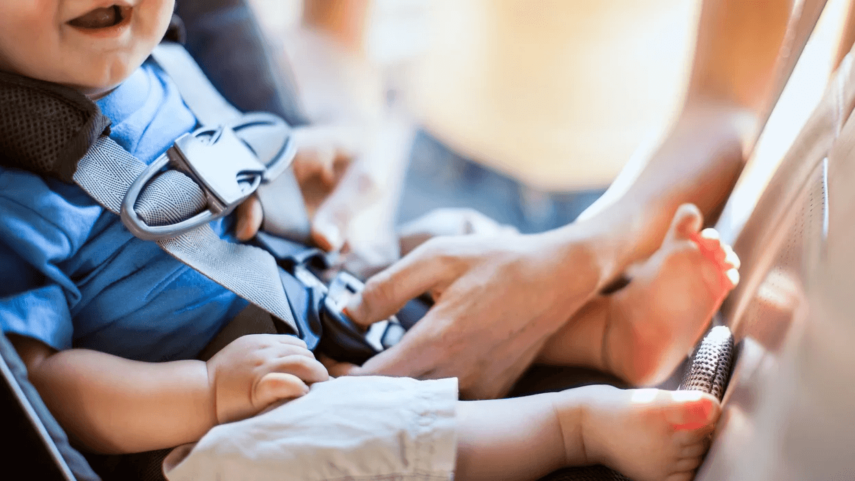 The important safety tip parents need to know about sleep & car seats parent adjusting baby in a car seat - car seat safety tips