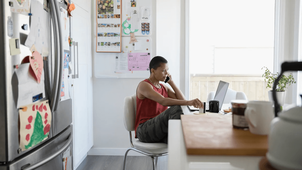 4 simple ways to ease that back-to-school stress, mama person-sitting-at-a-table-on-a-computer-and-on-the-phone