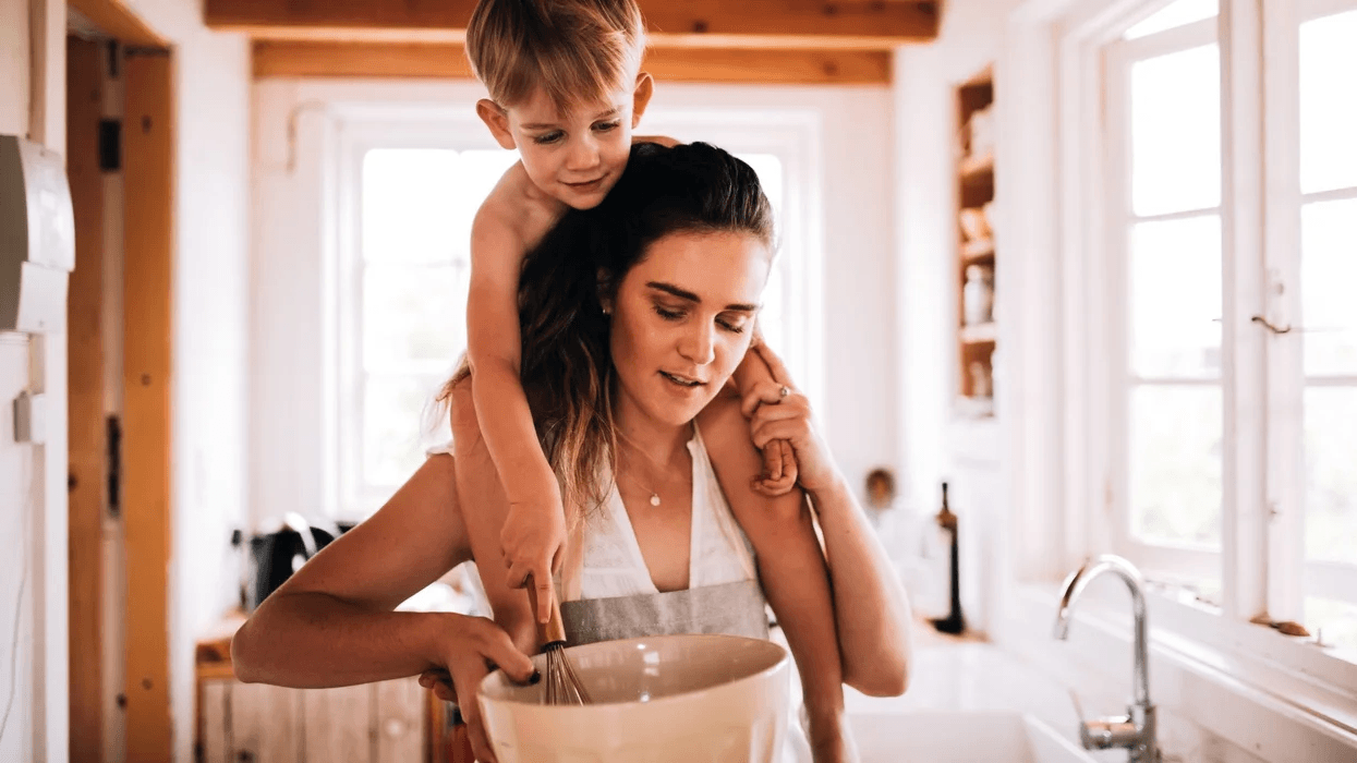 To the SAHM who is ALWAYS working—I see you woman cooking with a child on her shoulders