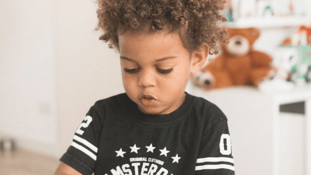 Montessori at home: 7 ways to prepare your child for preschool little boy playing with toys working on montessori at home techiniques