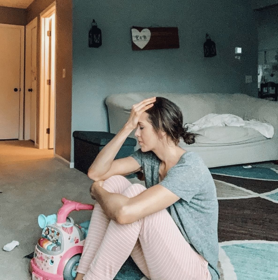 This is what motherhood looks like when no one’s watching mom sitting on the floor with head in her hands