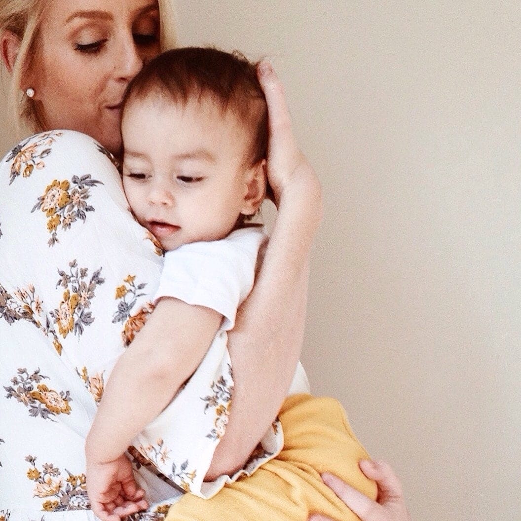 Calm mama: The 2 techniques that teach toddlers to handle their emotions mom comforting child against her shoulder