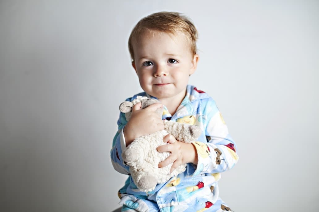 A toddler’s guide to bedtime stalling—in 30 steps toddler holding a stuffed animal