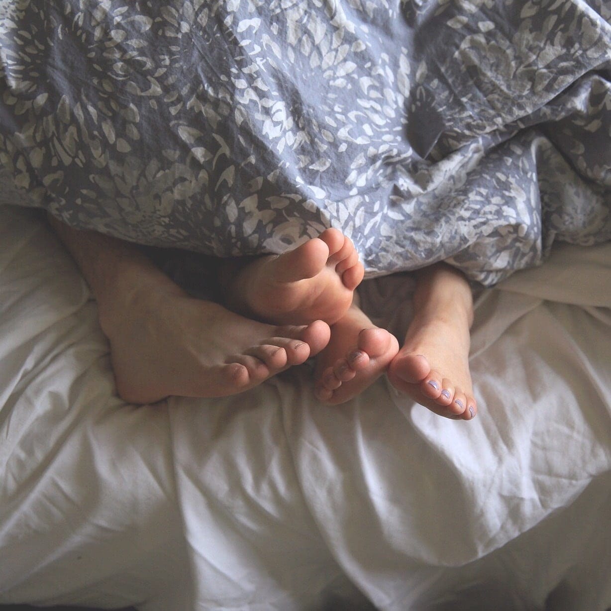 Hot sex after baby is possible—here’s how couples feet at the end of their bed