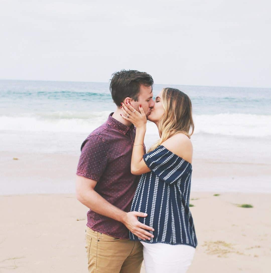 6 things men worry about while trying to conceive couple kissing on the beach