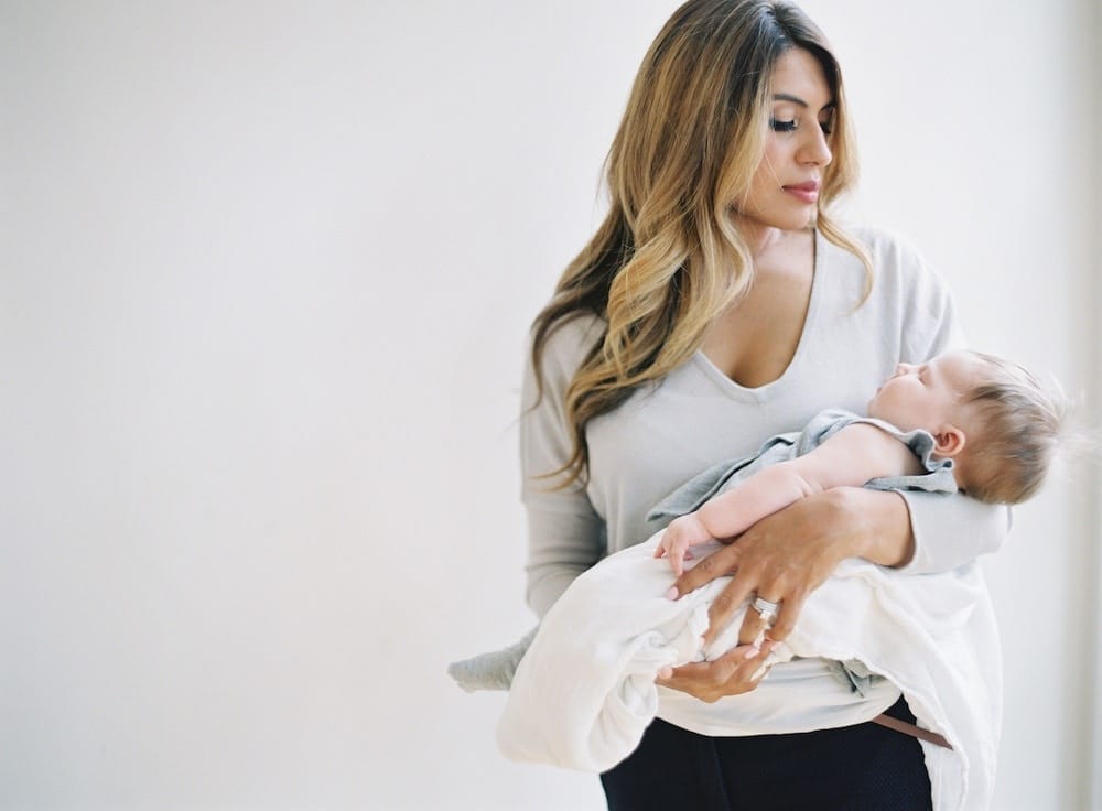 Motherhood is hard, but all your baby really needs are these 5 simple habits woman holding newborn baby