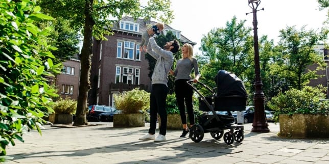 Baby gear trends to watch for in 2017 parents taking child for a walk in a stroller
