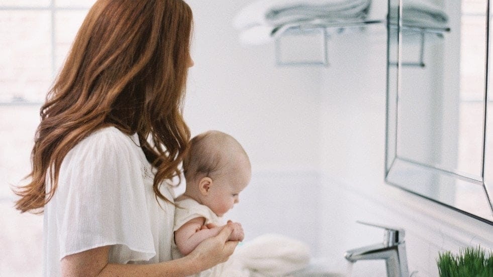 The self-care checklist that will refresh new mamas new mother holding baby - self-care checklist
